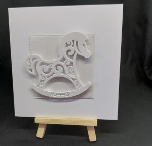 Handmade greetings card featuring a cut-out rocking horse - created by Bat Cave Cards