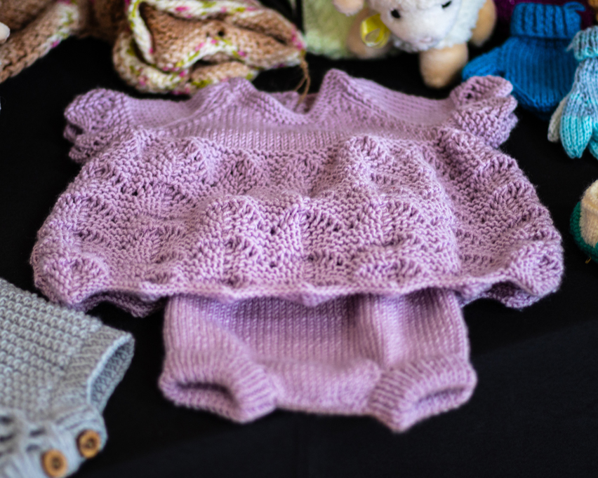 Hand knitted baby outfit by Valtos Hand Knits - taken at the 2024 Easter Craft Fair by the Helensburgh and Lomond Artisans Association (HLAA)